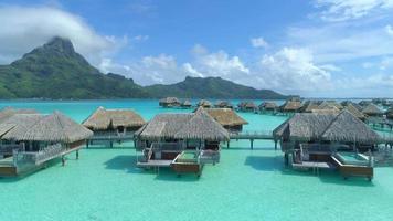 Aerial drone view of a luxury resort and overwater bungalows in Bora Bora tropical island. video