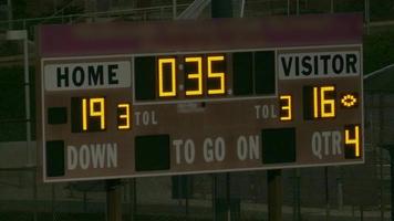 Scoreboard at a night football game stadium, Friday night lights, American football. video