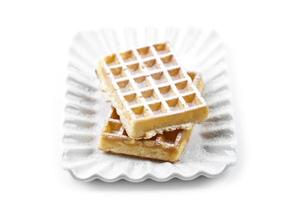 Belgium waffers with sugar powder on ceramic plate isolated on white background. photo