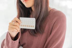 Asian women holding Birth control pill photo