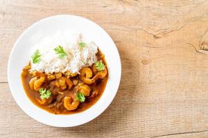 Shrimps in curry sauce on rice photo