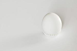White egg on a white isolated background with shadow. Ingredient.Healthy food.Easter. photo