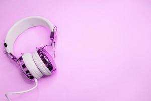 Music background with purple headphones photo