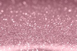 Rose gold festive glitter background. Shallow depth of field, blurred bokeh effect photo