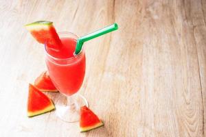 Watermelon smoothie on natural wooden floor for summer drinks concept photo