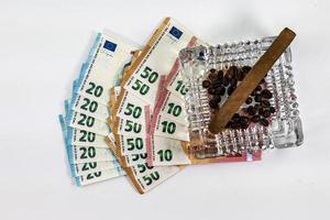 50 20 10 euro banknotes with ashtray and cigar