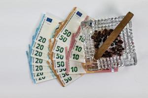 50 20 10 euro banknotes with ashtray and cigar