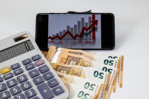 euro banknotes with calculator and graph photo
