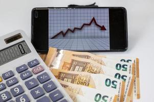 euro banknotes with calculator and graph photo