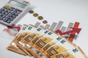 50 euro banknotes with graphs and calculator photo