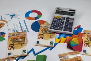 50 euro banknotes with statistics and calculator photo