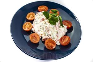 Russian salad on blue plate photo