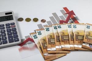 50 euro banknotes with graphs and calculator photo