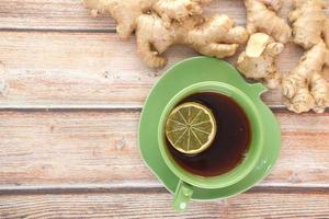 Top view of ginger tea on wooden background. photo