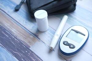 Close up of diabetic measurement tools and pills on color background photo