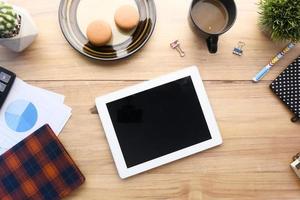 Flat composition of digital tablet and office stationary on black background photo