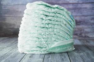 Stack of baby diaper on table, photo