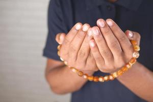 Muslim man keep hand in praying gestures during ramadan, Close up photo