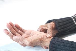 Elderly woman suffering from pain isolated on white photo