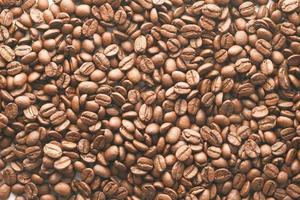 Top view of fresh coffee beans on black background photo