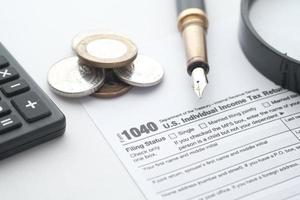 Close up of a Tax return form and pen on table. photo