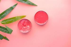 Top view of pink color petroleum jelly in a container photo