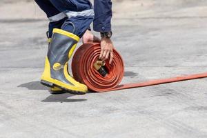 Firemen in firefighter uniform are keep their equipment after use photo