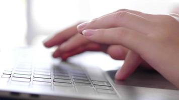 Close up of Asian woman typing on a laptop at home video