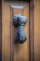 knocker in the shape of a knocking hand photo
