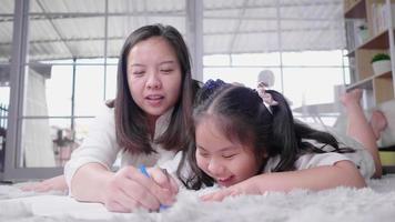 Mom and kid lying on the floor and drawing video