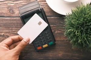 Concepto de pago sin contacto con joven pagando con tarjeta de crédito