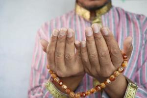 Muslim man keep hand in praying gestures during ramadan, Close up photo