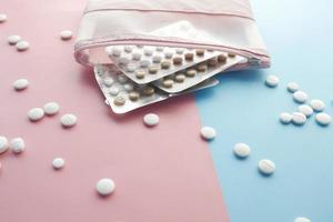 Birth control pills on color background, close up