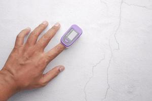 Close up of man hand using pulse oximeter photo