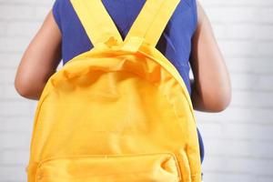 Child girl with school bag ready to go to school