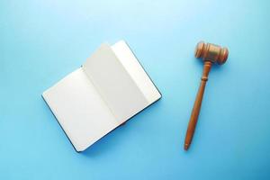 Gavel and book with copy space on blue background photo