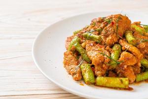 Stir fried pork and red curry paste with sting bean photo