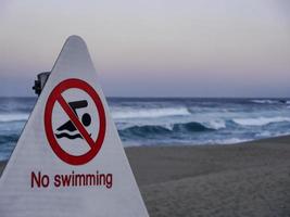 No swimming. Signpost on Sokcho beach. South Korea. photo
