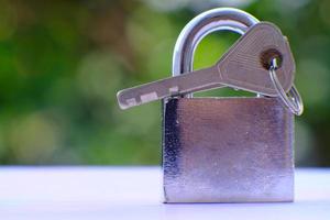 Padlock on green bokeh background and business security concept, protecting data personal information photo