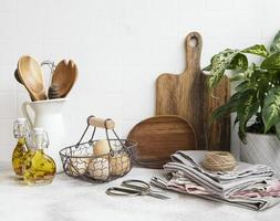 Kitchen utensils, tools and dishware on on the background white tile wall. photo