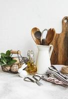 Kitchen utensils, tools and dishware on on the background white tile wall. photo