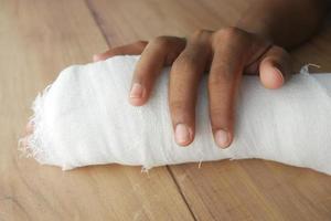 Injured painful hand with bandage photo