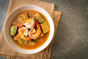 Sour soup made of Tamarind Paste with Shrimps and Vegetable Omelet photo