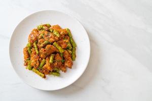 Stir fried pork and red curry paste with sting bean photo