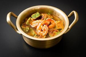 Sour soup made of Tamarind Paste with Shrimps and Vegetable Omelet photo