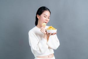 Young Asian woman eat potato chips photo