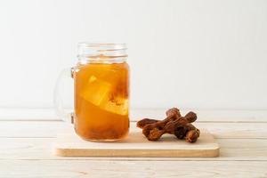 Delicious sweet drink tamarind juice and ice cube photo