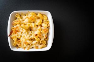 American mac and cheese, macaroni pasta in cheesy sauce photo