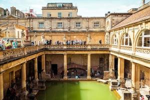 BATH, ENGLAND - AUG 30, 2019 - Roman Baths, the UNESCO World Heritage site with people, which is a site of historical interest in the city of Bath. photo