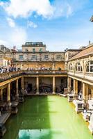 BATH, ENGLAND - AUG 30, 2019 - Roman Baths, the UNESCO World Heritage site with people, which is a site of historical interest in the city of Bath. photo